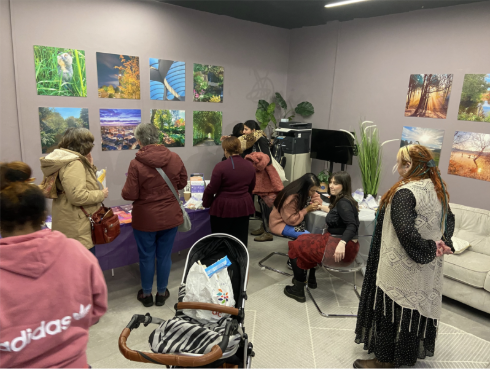 Women gathering around the entrance room looking at the calming imagery in the grey room